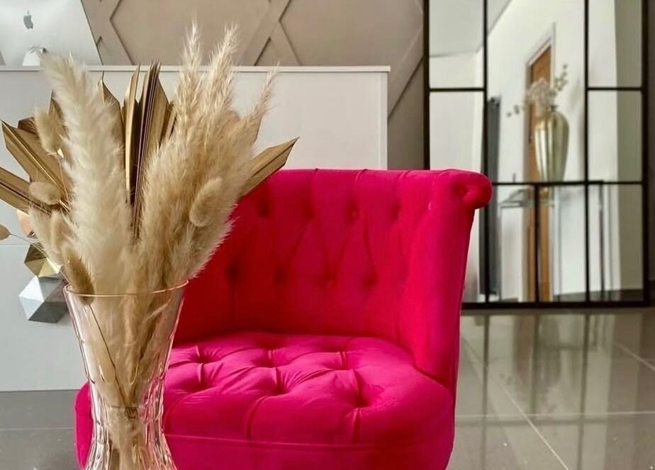 Vibrant pink chair in stylish decor at Rhianne Orla Skin, Broxburn, Scotland, GB.