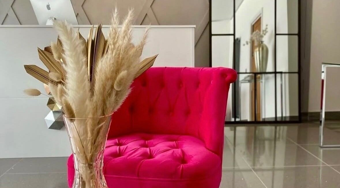 Vibrant pink chair in stylish decor at Rhianne Orla Skin, Broxburn, Scotland, GB.