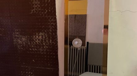 Barbiere mirror in Tržič, Tržič, SI captures elegant interior with chair and lamp.