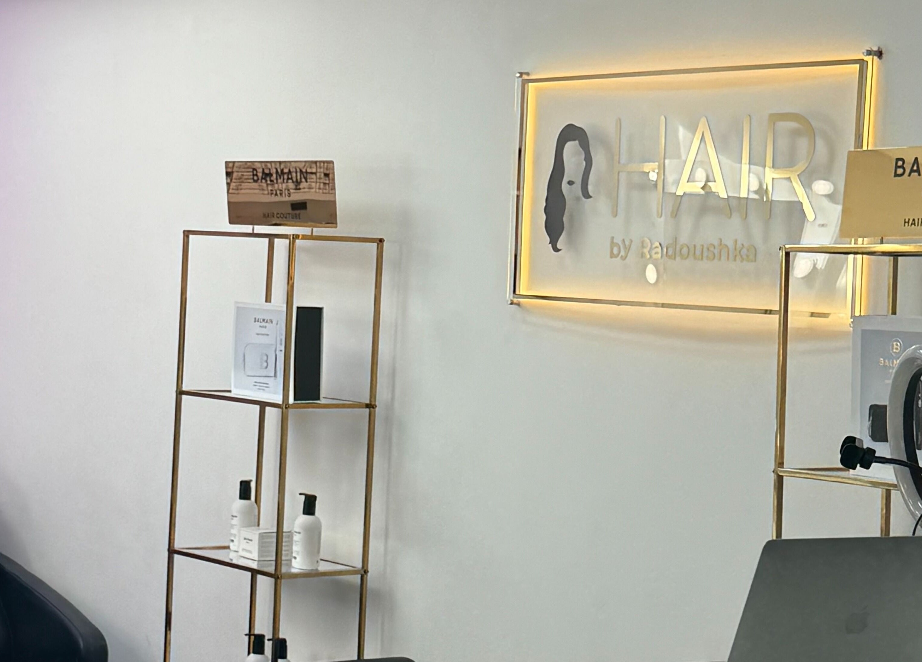 Interior of Hair By Radoushka in London, England, GB with Balmain products on display and stylish decor.