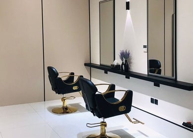 Modern salon stations at Beauty Look Ladies Care Center, Sharjah, AE, featuring elegant styling chairs and mirrors.