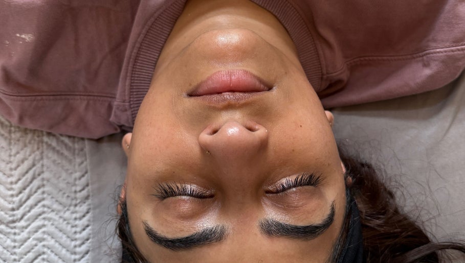 Relaxed client with closed eyes at Serene with Queen, Leicester, England, GB, showcasing brow and lash treatment.