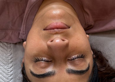 Relaxed client with closed eyes at Serene with Queen, Leicester, England, GB, showcasing brow and lash treatment.