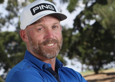Man in blue shirt and cap at Adam Bland Golf, Flagstaff Hill, South Australia, AU.