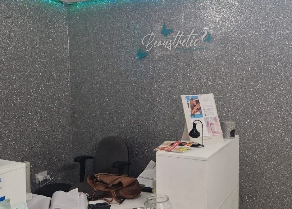 Reception area with glittering wall at Zamira Nails, Birmingham, England, GB showcasing beauty brochures.
