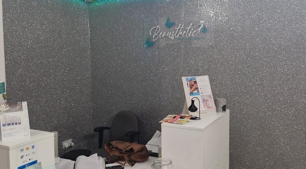 Reception area with glittering wall at Zamira Nails, Birmingham, England, GB showcasing beauty brochures.