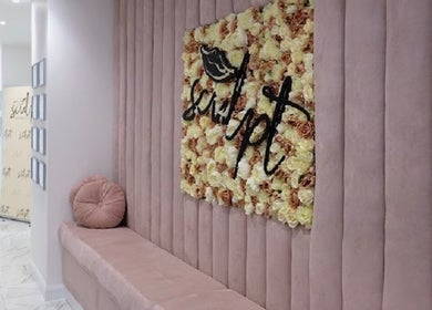 Elegant lobby at Simply Glamorous Aesthetics, Paisley, Scotland, GB with plush seating and floral decor.