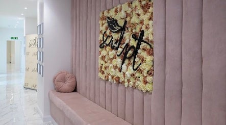 Elegant lobby at Simply Glamorous Aesthetics, Paisley, Scotland, GB with plush seating and floral decor.