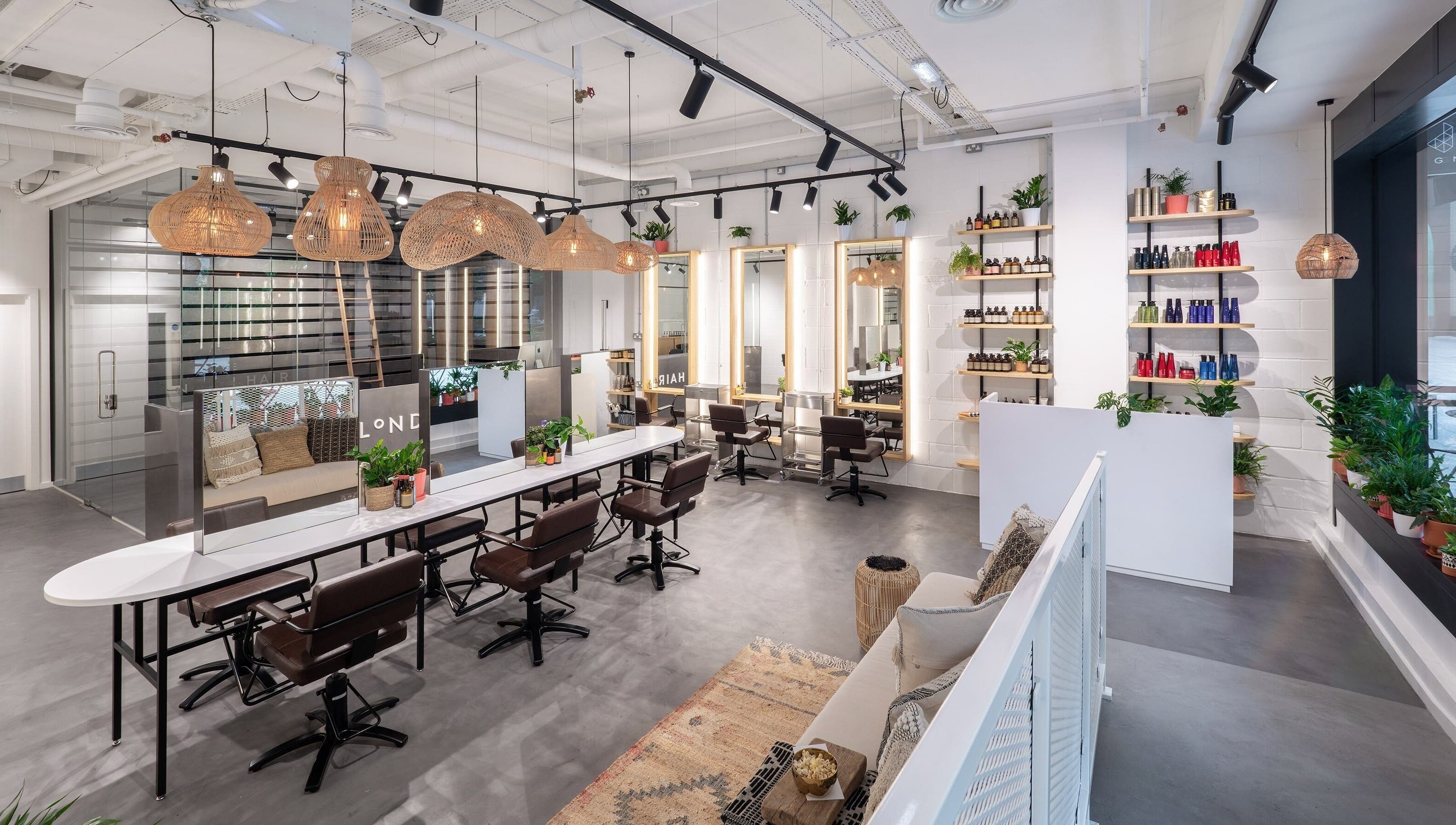 Modern interior of Vixen & Blush Hair Extensions in London, England, GB showcasing sleek salon chairs and decor.