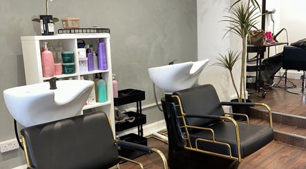 Chic salon interior at Adriana Guzman Hairdresser, Dublin, County Dublin, IE, featuring modern black salon chairs.