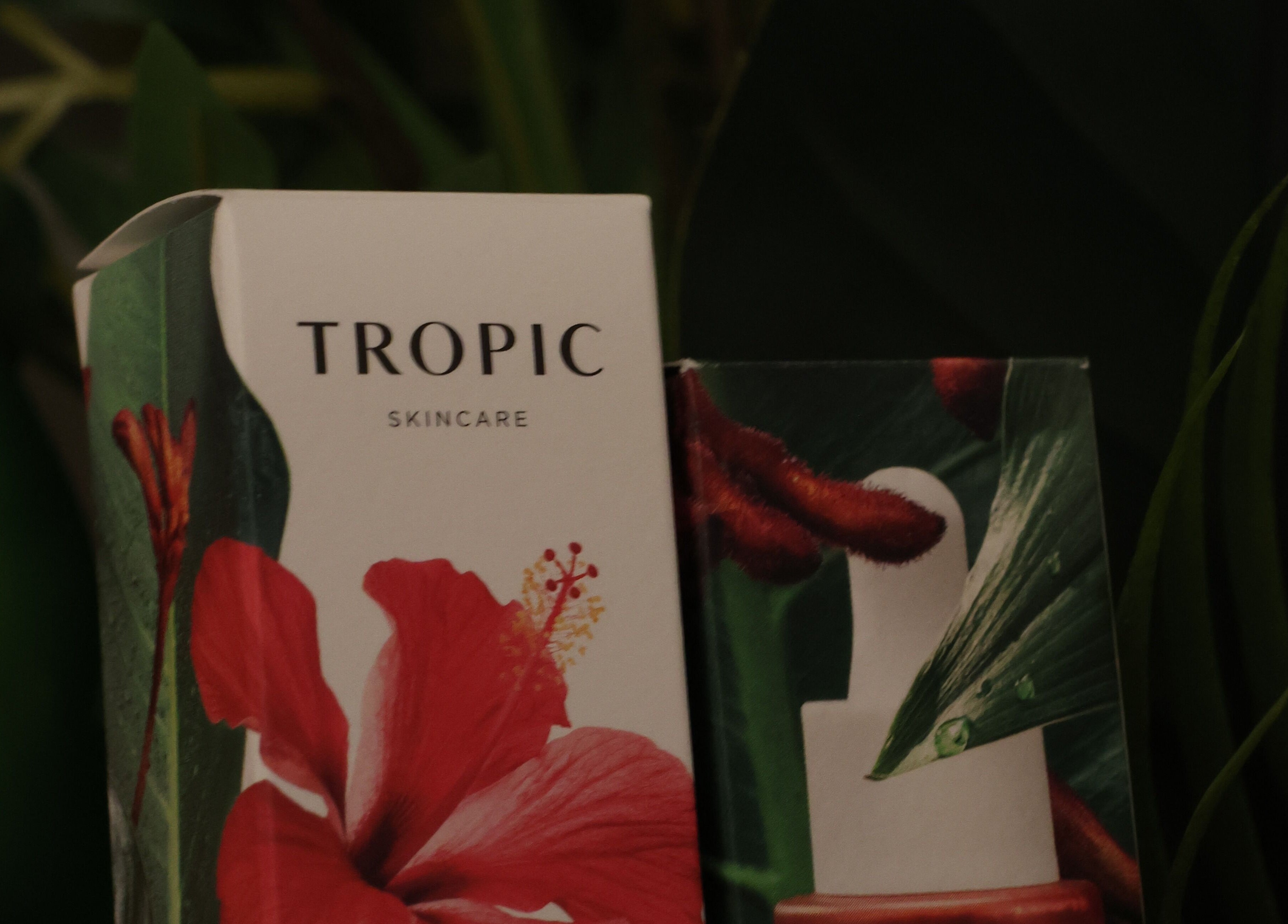 Tropic Skincare products at Spa Ukiyo, Stafford, England, GB, surrounded by lush green leaves.