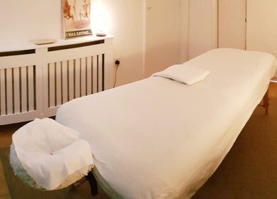 A peaceful massage room at Everwell Massage Therapies - Lynnea, Brynsadler, Wales, GB, featuring a cozy massage bed.