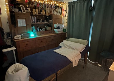 Cozy massage room at Everwell Massage Therapies - Lynnea in Brynsadler, Wales, GB, adorned with calming lighting.