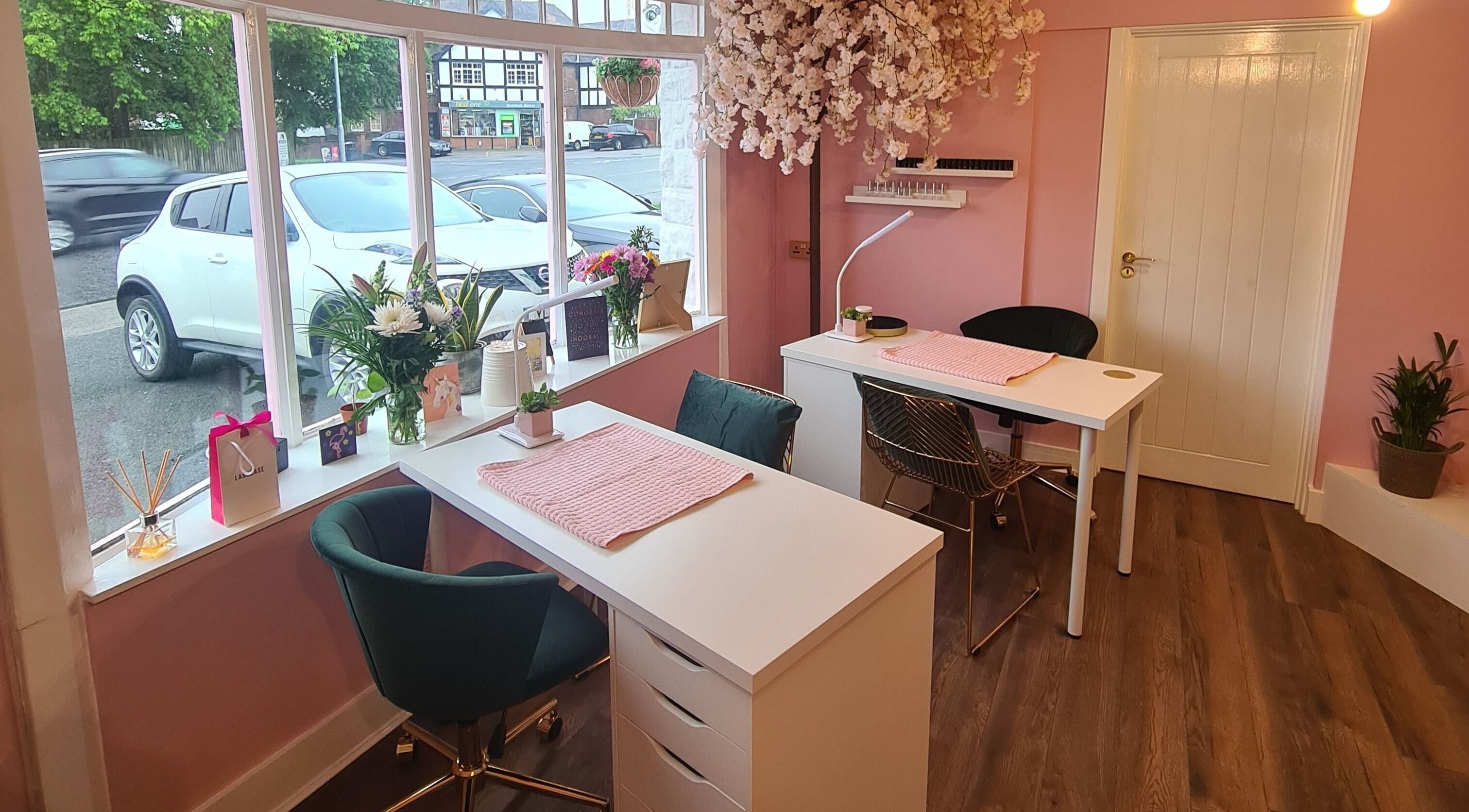 Cozy salon corner at The Beauty Box Leeds with pink decor and floral accents in Leeds, England, GB.
