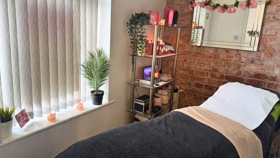 Relaxing treatment room at Clarissa K Beauty Boutique, Blackpool, England, GB with elegant decor and cozy bed.