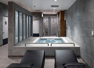 Relaxing spa area at Adam Emblen - Personal Training in Manchester, England, GB with loungers and a hot tub.