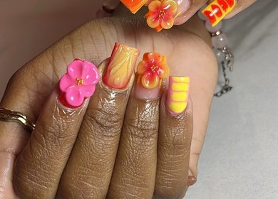 Vibrant floral nail art at Klassybarbz, Scarborough, Tobago, TT showcasing intricate 3D designs.