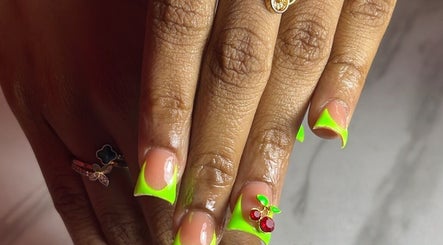 Neon green french tip nails with cherry accents at Klassybarbz, Scarborough, Tobago, TT.