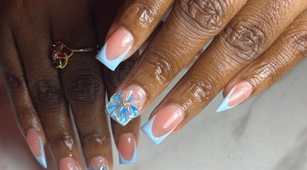 Elegant floral nail art with blue tips at Klassybarbz, Scarborough, Tobago, TT.