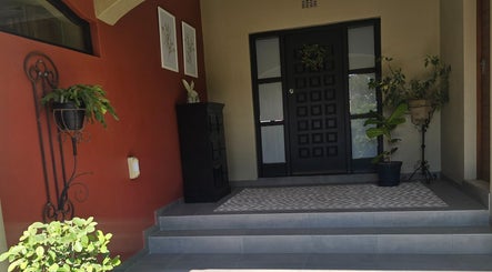 Inviting entrance at Dr Maritza Nienaber's venue in Middelburg, Mpumalanga, ZA with potted plants and decor.