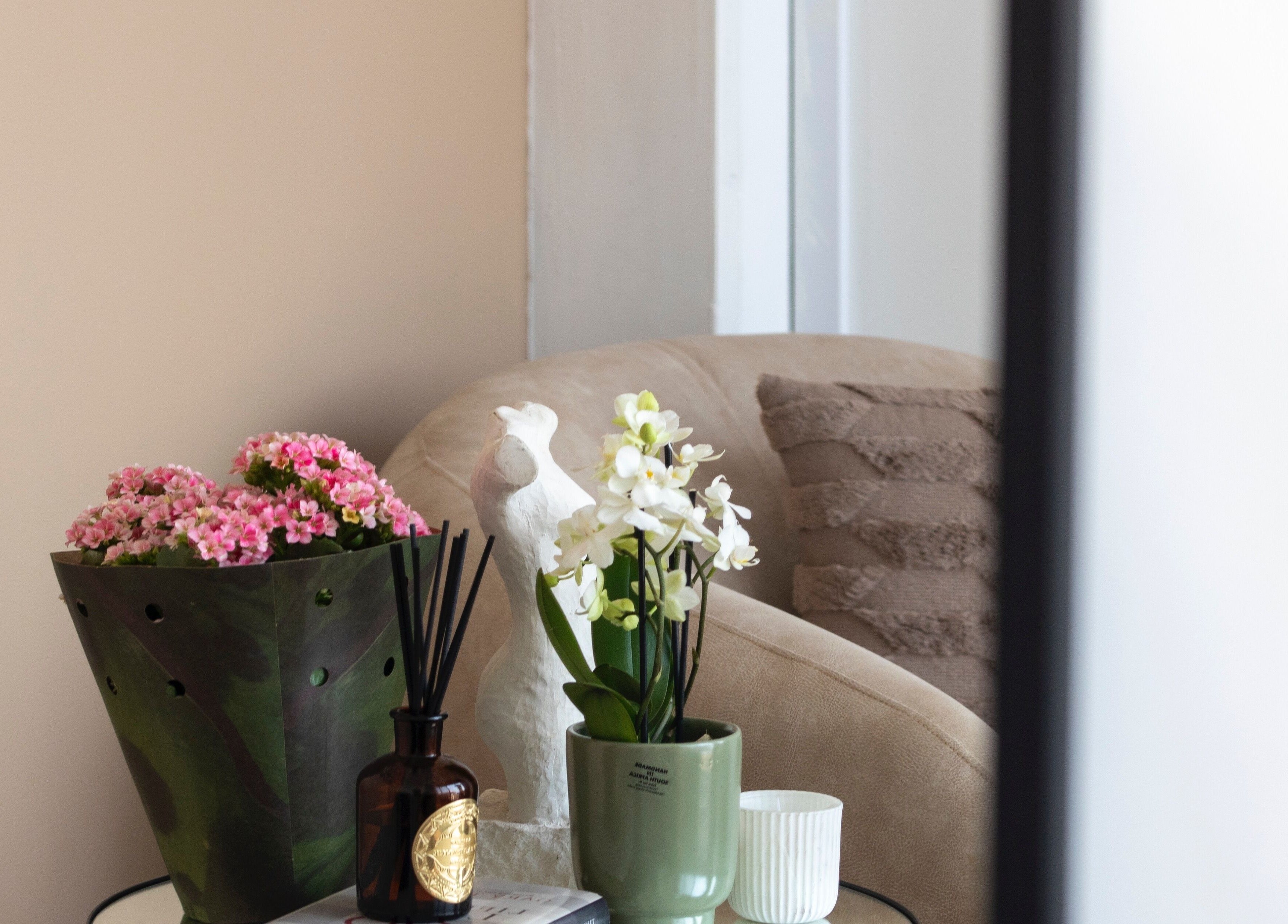 Elegant seating area at Kayswaxingroom, Umhlanga, Kwazulu-natal, ZA with flowers and calming decor.