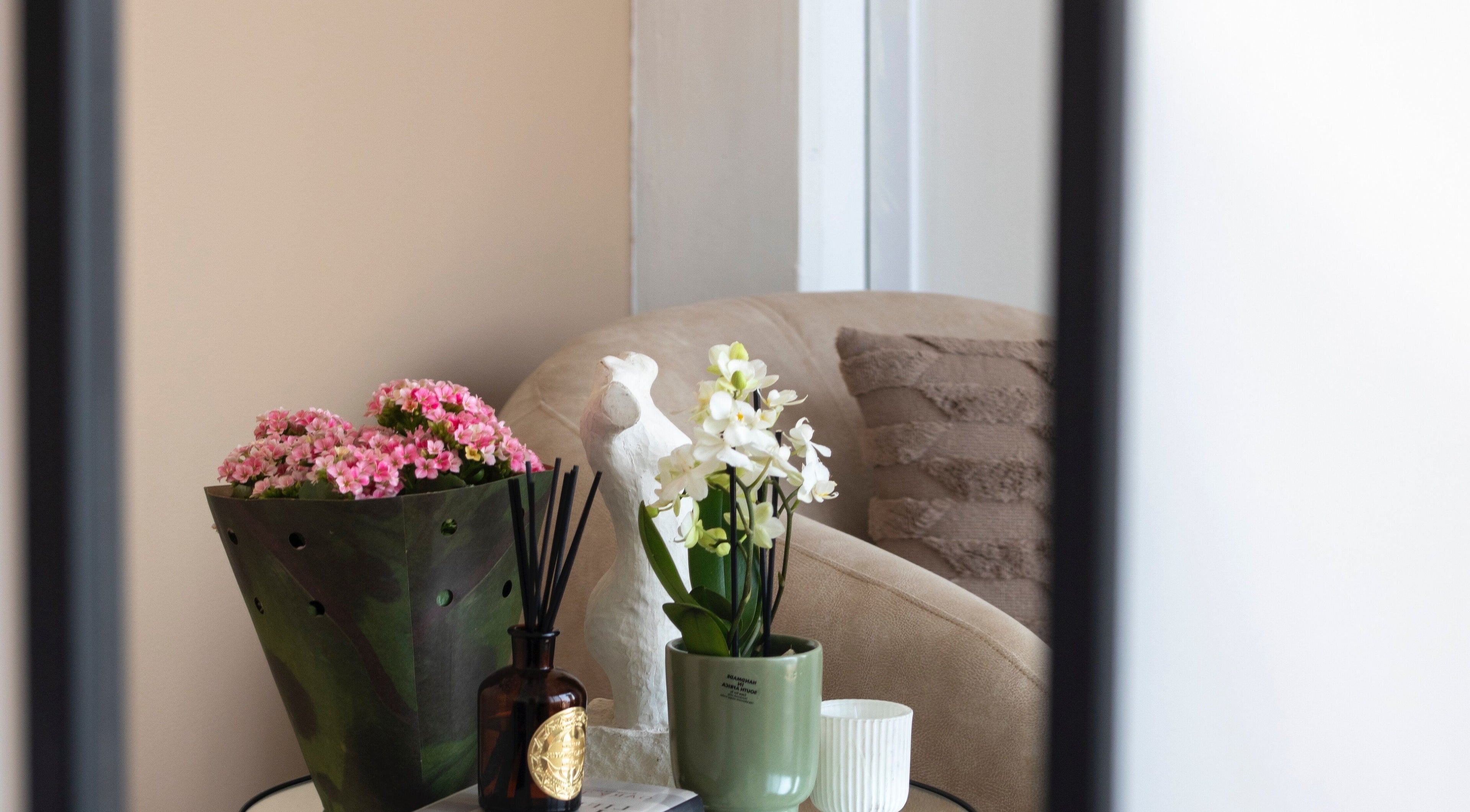 Elegant seating area at Kayswaxingroom, Umhlanga, Kwazulu-natal, ZA with flowers and calming decor.