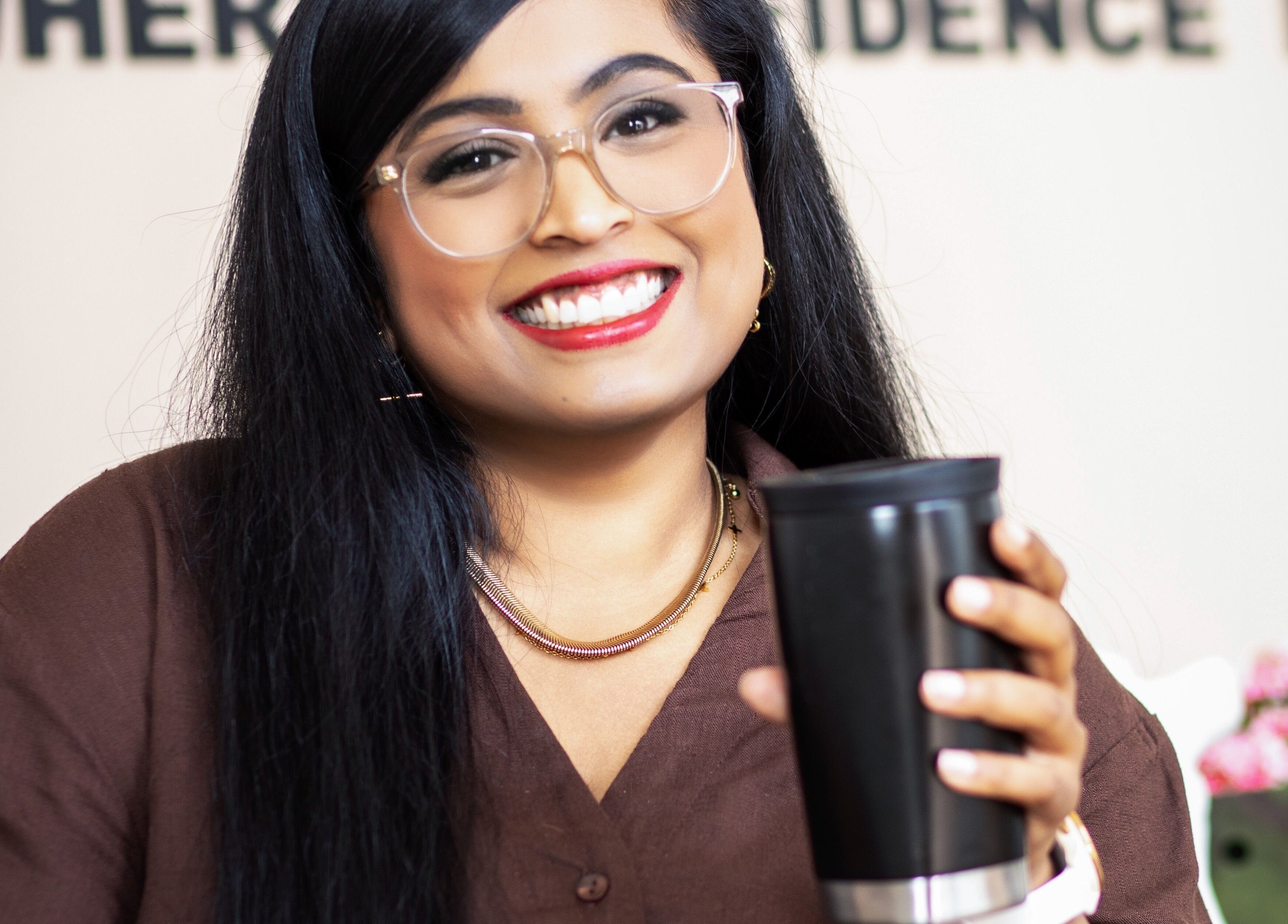 Smiling person holding a coffee mug at Kayswaxingroom, Umhlanga, Kwazulu-natal, ZA.