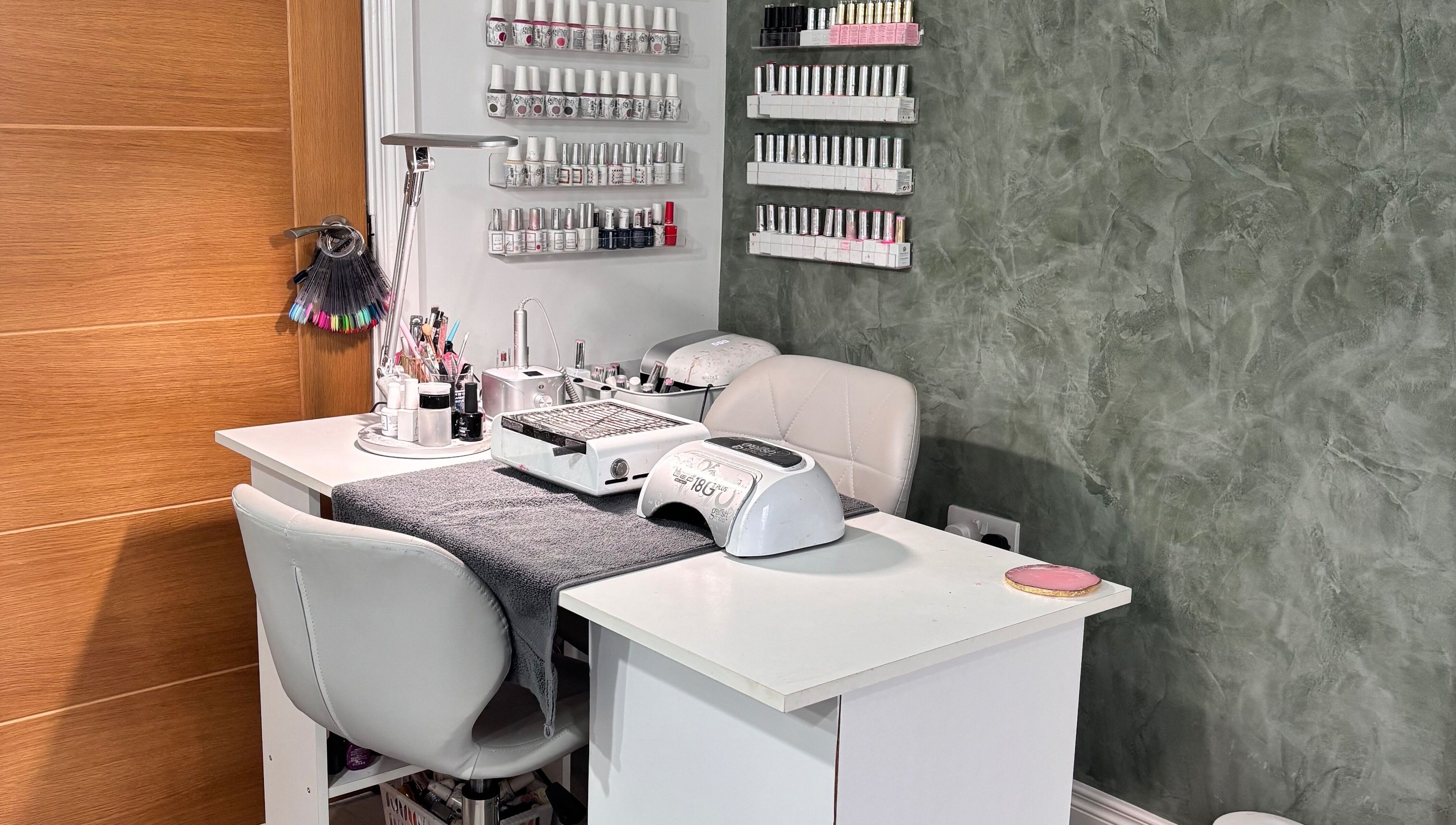 Nail station at SD Makeup Artistry, Castlereagh with gel polish on display and modern decor.