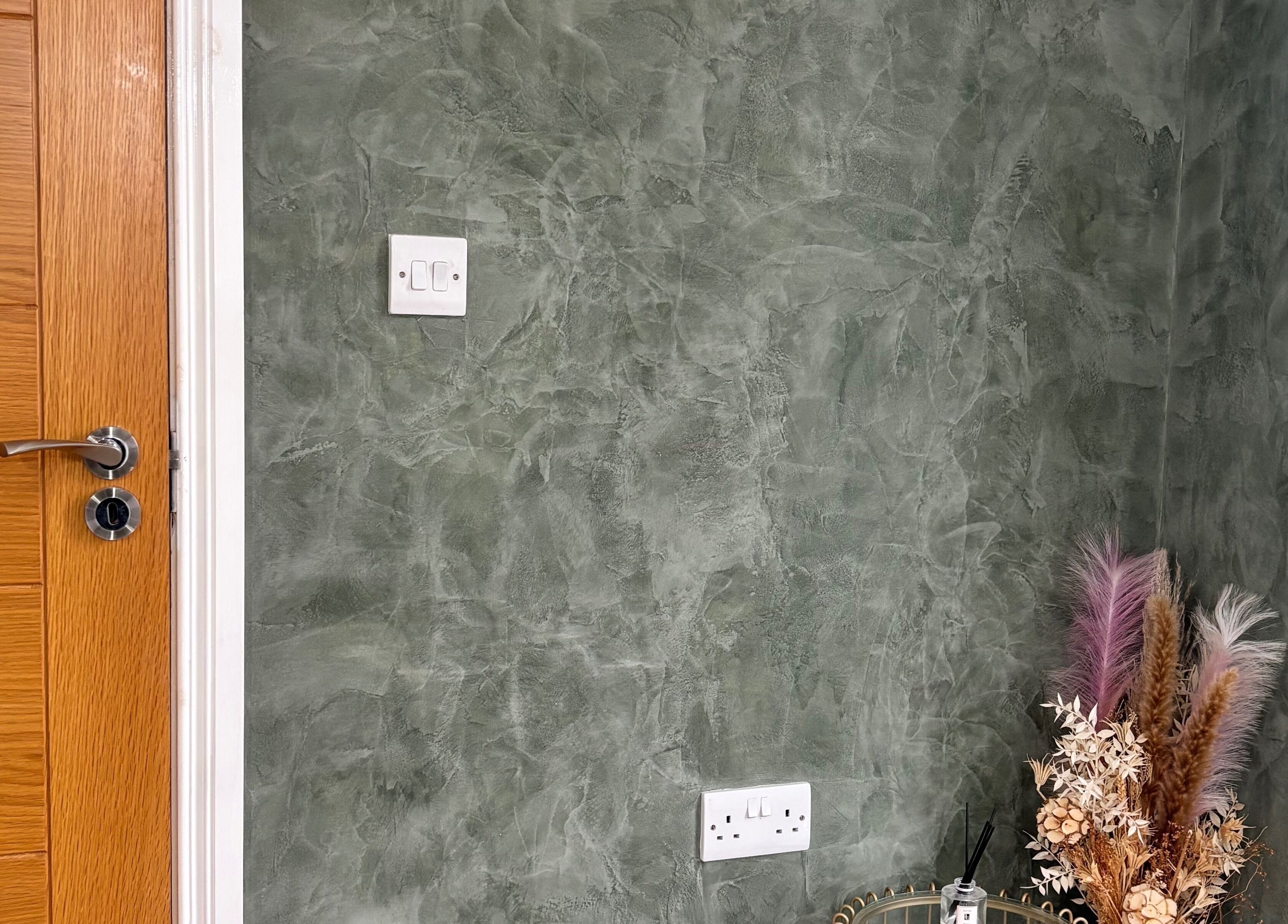 Textured green wall with door and dried florals at SD Makeup Artistry, Castlereagh, Northern Ireland, GB.