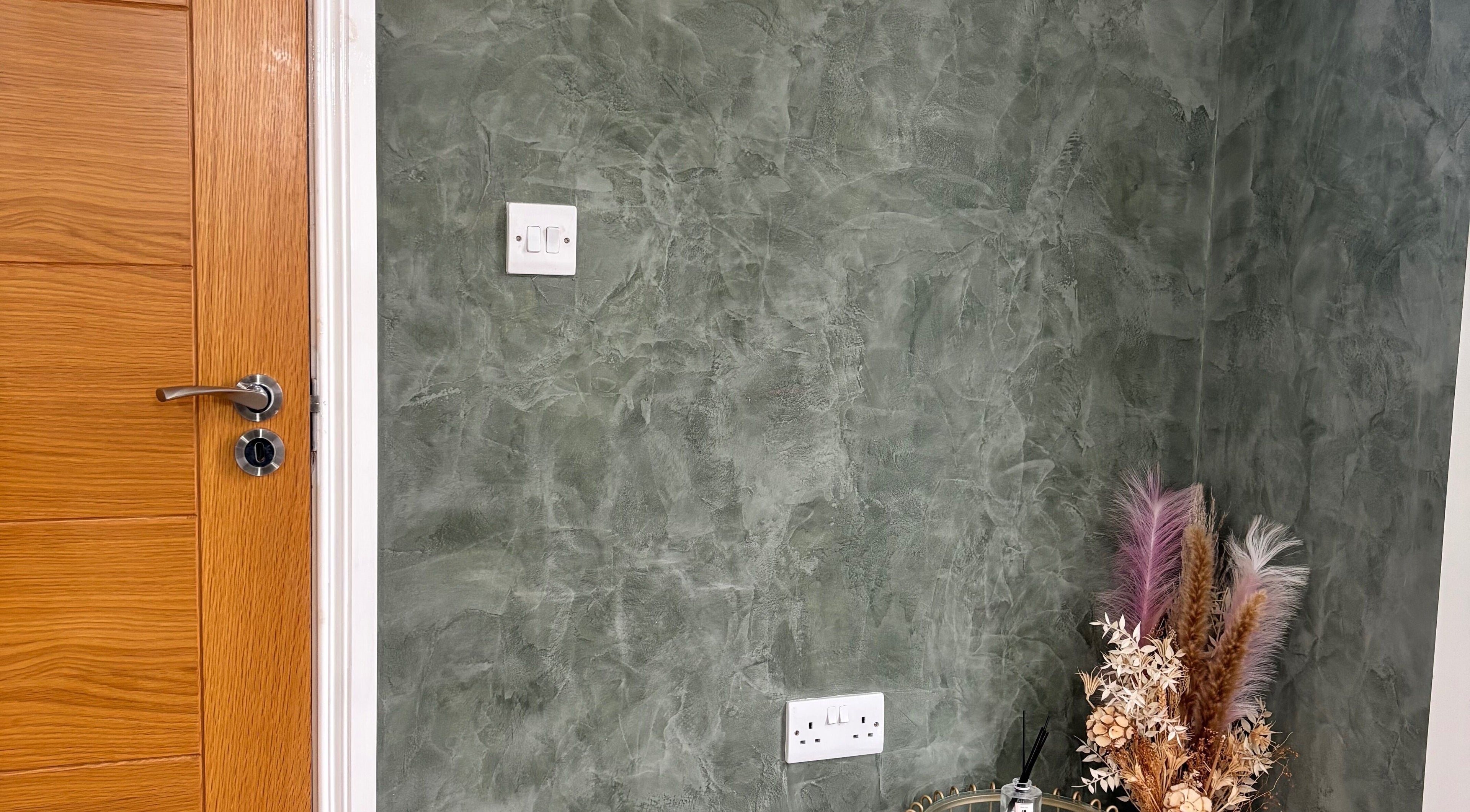 Textured green wall with door and dried florals at SD Makeup Artistry, Castlereagh, Northern Ireland, GB.