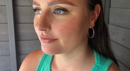 Close-up of a woman's serene face at Ivy Bloom, Coggeshall, England, GB showcasing natural makeup.