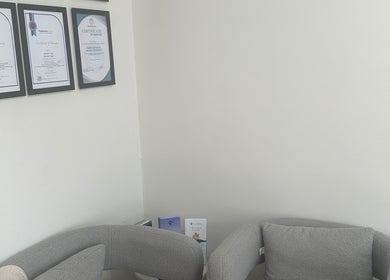 Certificates on display at Nurse Jenni Medical Aesthetics and Skin Clinic, Warrington, England, GB, featuring cozy seating.