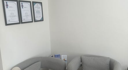 Certificates on display at Nurse Jenni Medical Aesthetics and Skin Clinic, Warrington, England, GB, featuring cozy seating.