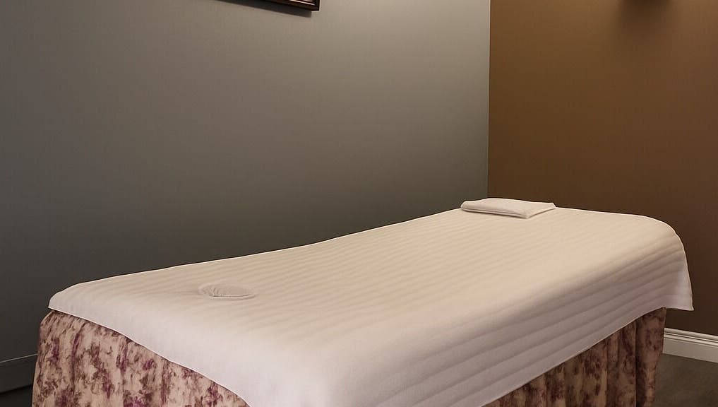 Massage table in a tranquil room at Bosmar Spa, San Diego, California, US, promising relaxation.
