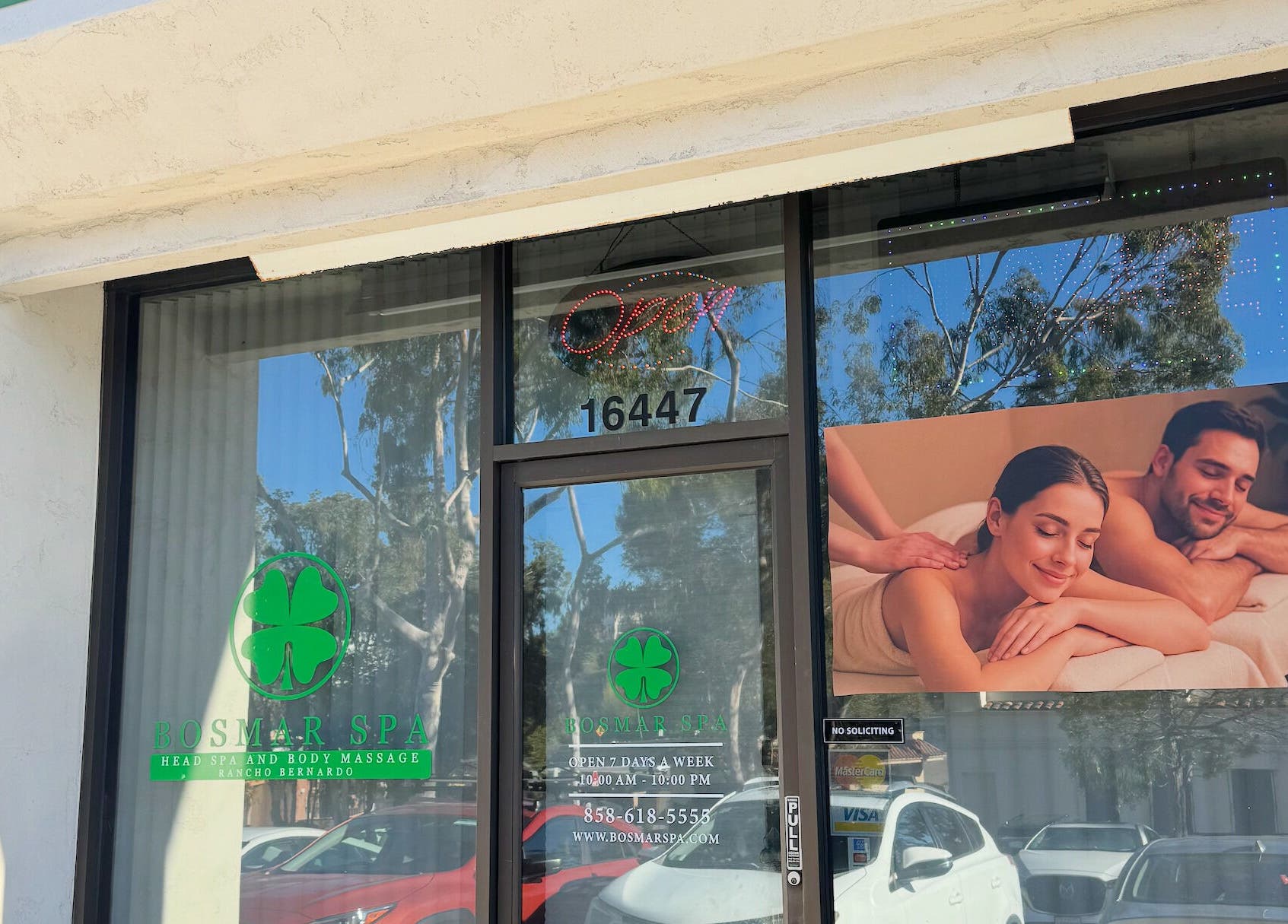 Entrance of Bosmar Spa in San Diego, California, US, featuring a welcoming sign and massage imagery.