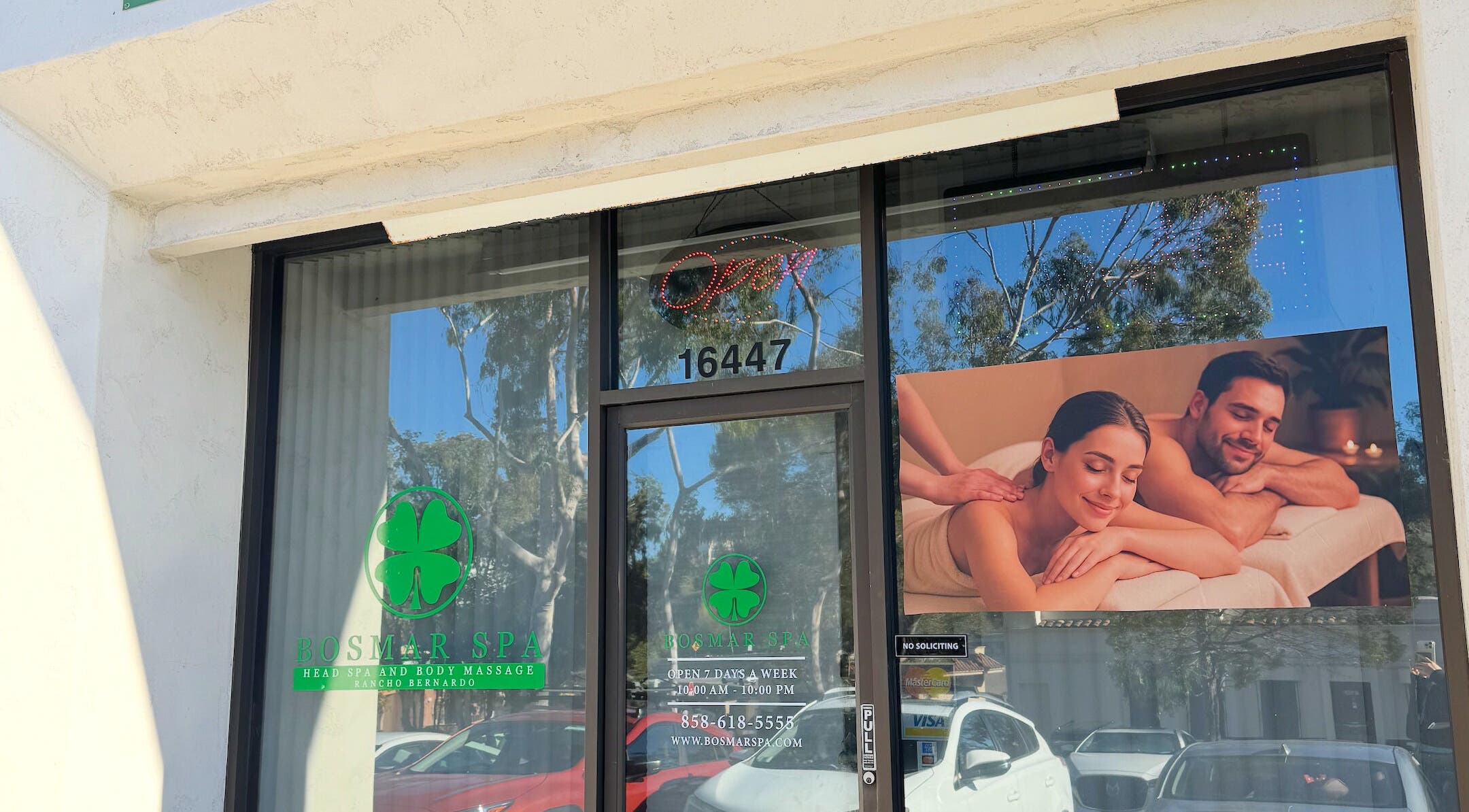 Entrance of Bosmar Spa in San Diego, California, US, featuring a welcoming sign and massage imagery.