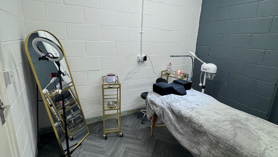 Treatment room at House of Gaia, Aberbargoed, Wales, GB, featuring spa bed, mirror, and equipment.