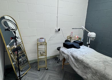 Treatment room at House of Gaia, Aberbargoed, Wales, GB, featuring spa bed, mirror, and equipment.