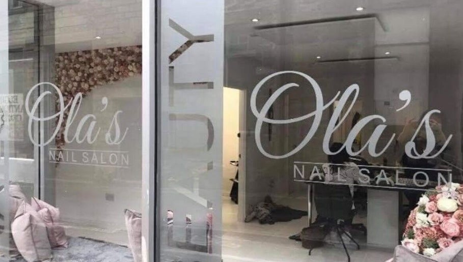 Chic window display of Nails By Kc at Elgin, Scotland, GB with elegant salon interior.