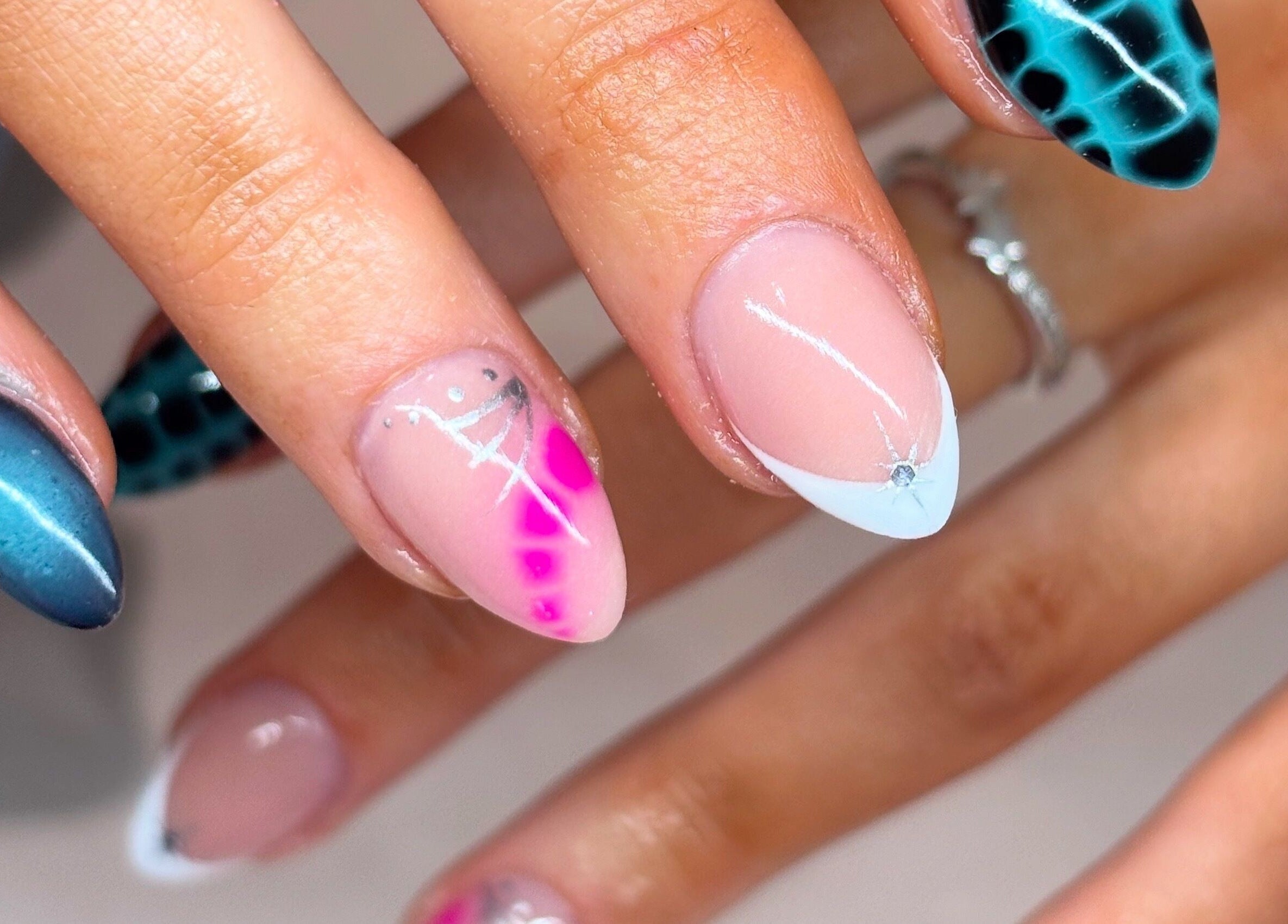 Vibrant nail art at Nails By Kc, Elgin, Scotland, GB showcasing multicolor and geometric designs.