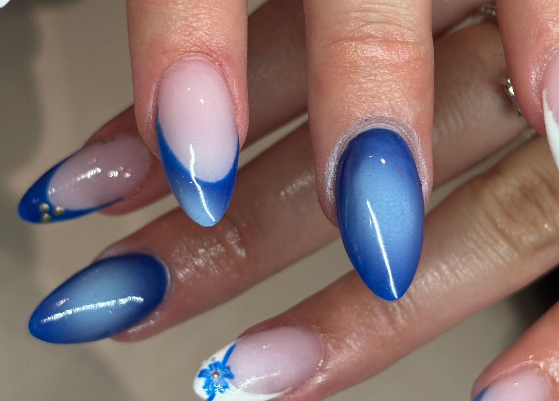 Elegant blue and white nail art at Nails By Kc, Elgin, Scotland, GB showcasing intricate floral designs.