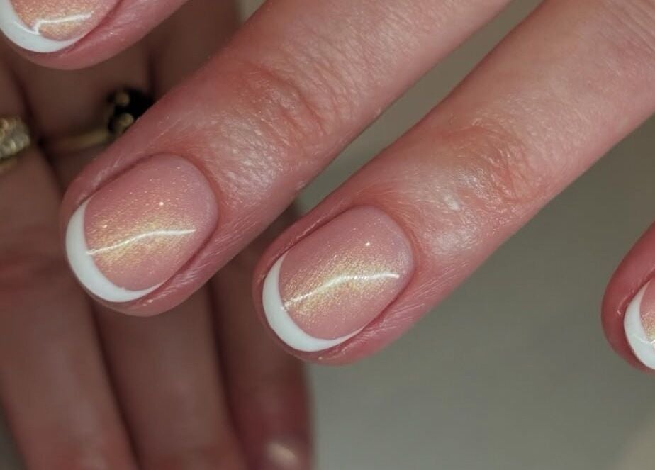 Elegant French manicure with soft shimmer at Nails By Kc, Elgin, Scotland, GB.