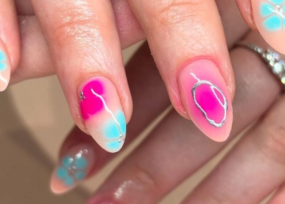 Close-up of vibrant floral nail art at Nails By Kc, Elgin, Scotland, GB, showcasing intricate designs.