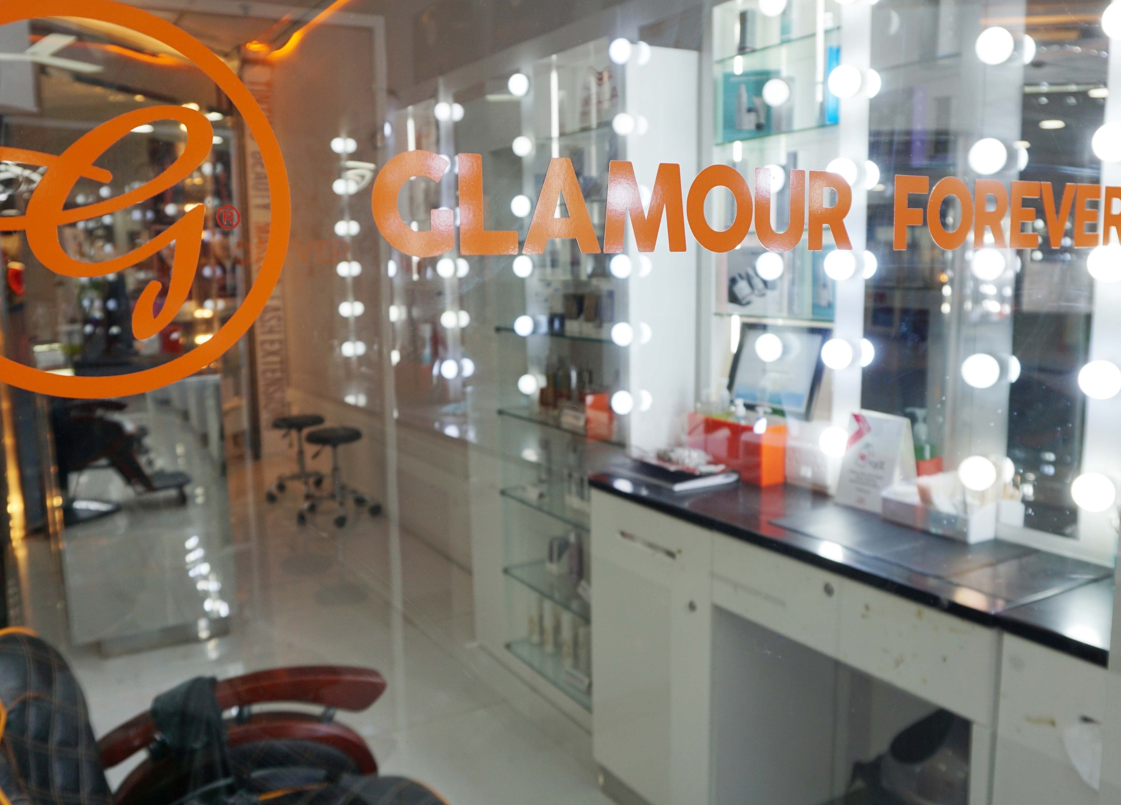 Inside view of Glamour Forever Preston's stylish salon with lighted mirrors in Preston, England, GB.