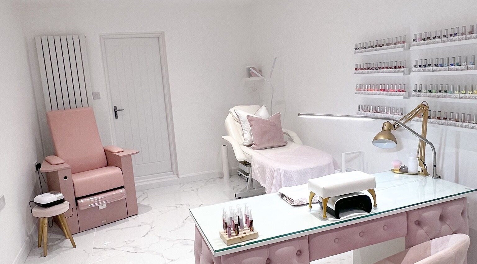 Elegant treatment room at Beauty Bungalow, Preston, United Kingdom, GB featuring plush seating and nail polish display.
