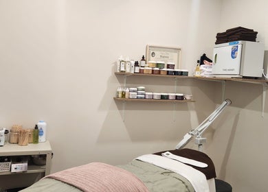 Devo Esthetics treatment room with cozy bed and beauty products in Ste-anne-de-prescott, Ontario, CA.