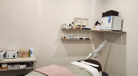 Devo Esthetics treatment room with cozy bed and beauty products in Ste-anne-de-prescott, Ontario, CA.