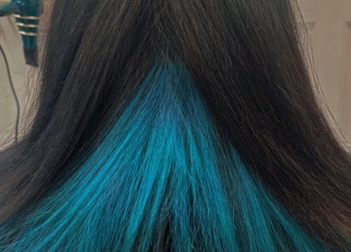 Blue-streaked hair styled at Becky’s Hairdressing mobile, Woodsetts, England, GB.