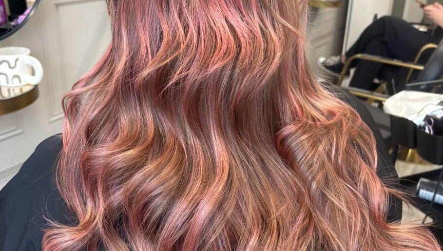 Vibrant wavy pink and brown hair styled at Becky’s Hairdressing mobile in Worksop, England, GB.