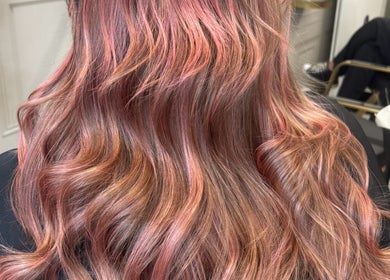 Vibrant wavy pink and brown hair styled at Becky’s Hairdressing mobile in Worksop, England, GB.